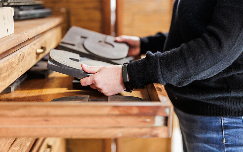 Woman holding letterpress blocks